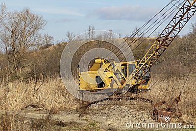 Abundant old, rusty mobile crane left on field. Stock Photo