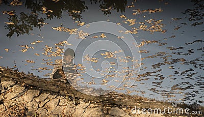 Abused child reflection on water Stock Photo