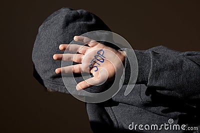 Abused teen with stop hand jesture Stock Photo