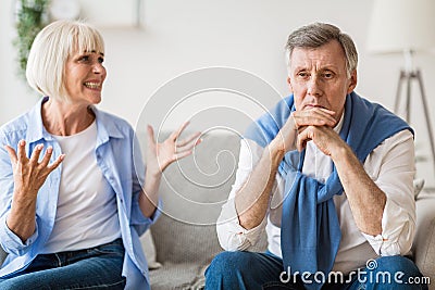 Abusive relationship. Angry woman shouting at husband Stock Photo