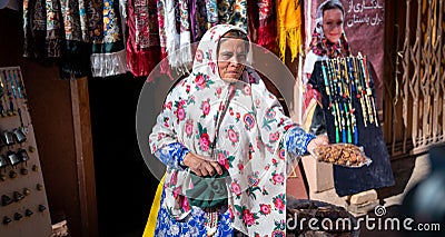 Woman with traditional Abyaneh Persian dess selling Iranian food in Abyahen, Iran Editorial Stock Photo