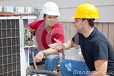 AC Technicians Discuss Problem Stock Photo