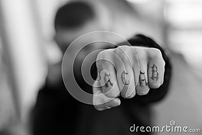 ACAB tattoo on the arm of a bully man. Black and white photo Stock Photo