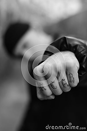 ACAB tattoo on the arm of a bully man. Black and white photo Stock Photo