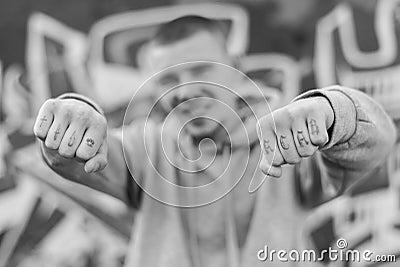 ACAB tattoo on the arm of a bully man. Black and white photo Stock Photo