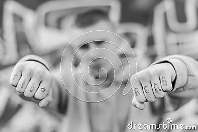 ACAB tattoo on the arm of a bully man. Black and white photo Stock Photo