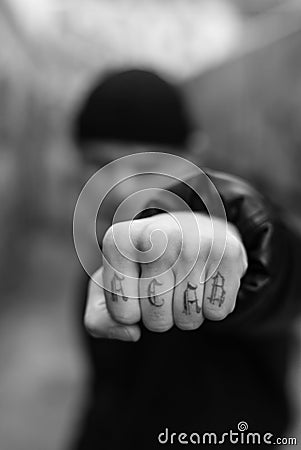 ACAB tattoo on the arm of a bully man. Black and white photo Stock Photo