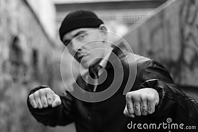 ACAB tattoo on the arm of a bully man. Black and white photo Stock Photo