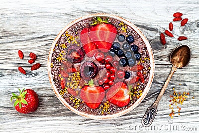 Acai breakfast superfoods smoothies bowl with chia seeds, bee pollen, goji berry toppings and peanut butter. Overhead Stock Photo