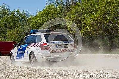 Accelerating Hungarian police car on a gravel road Editorial Stock Photo