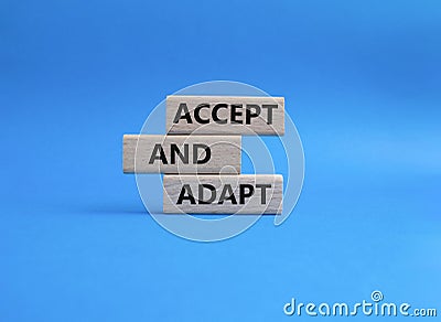 Accept or adapt symbol on Wooden blocks. Beautiful blue background. Business and 'Accept and adapt Stock Photo