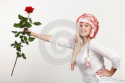 Woman in winter furry hat holding red rose Stock Photo