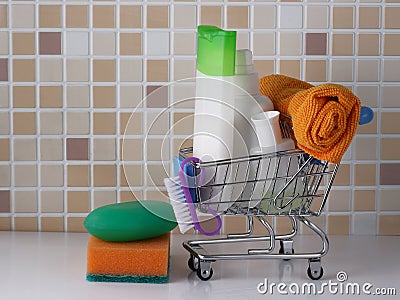 Accessories for laundry and cleanliness - soap, shampoo, towel in the shopping basket Stock Photo