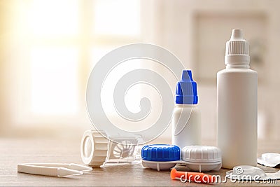 Accessories and products for contact lens maintenance on wood table Stock Photo