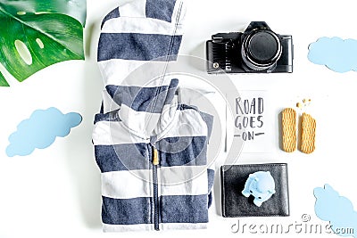 Accessories for treveling with children, camera and suit on white background top view Stock Photo