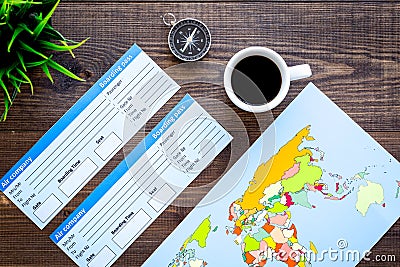 Accessories for treveling with tickets, map and coffee card on office desk wooden background top view Stock Photo