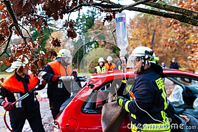 Accident - Fire brigade rescues Victim of a car crash Stock Photo