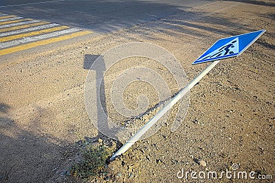 Accident at a pedestrian crossing. Downed pedestrian crossing road sign CIS Stock Photo