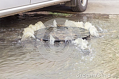 Accident sewerage system. Water flows over the road from the sewer. Water flows over the road from the sewer. Stock Photo