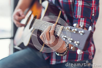 Accord chord, Close up of mens hands playing an acoustic guitar Stock Photo