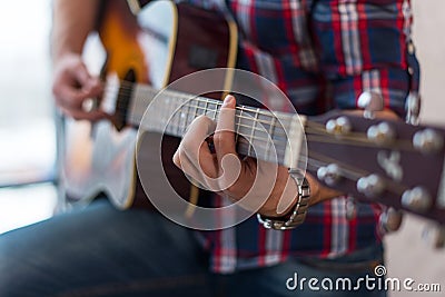 Accord chord, Close up of mens hands playing an acoustic guitar Stock Photo