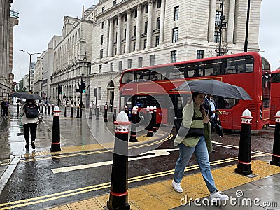 Rainy day in London city centre with people and umbrellas, England 2021 Editorial Stock Photo