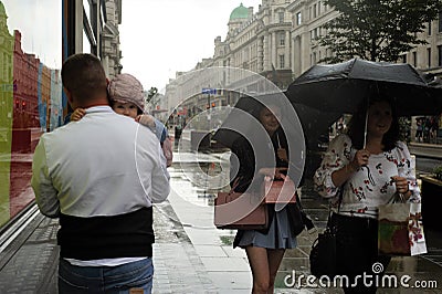 Rainy day in London city centre with people and umbrellas, England 2021 Editorial Stock Photo
