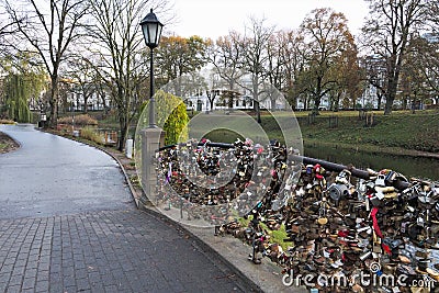 Riga, Latvia, November 2019. Locks on the bridge of lovers in a city park. Editorial Stock Photo