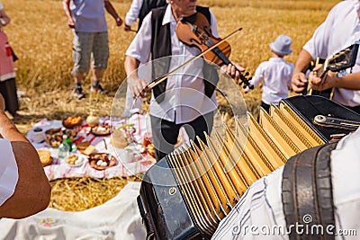 Accordionist stretches bellow of harmonic, music for good harvest Editorial Stock Photo