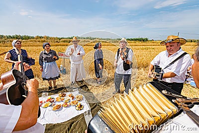 Accordionist stretches bellow of harmonic, music for good harvest Editorial Stock Photo