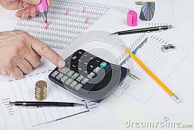 Accountant balancing a sales ledger with a calculator Stock Photo