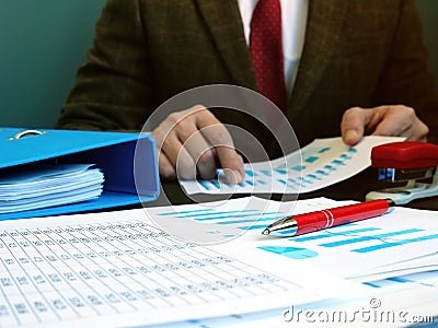 Accountant or businessman checks financial documents with charts Stock Photo
