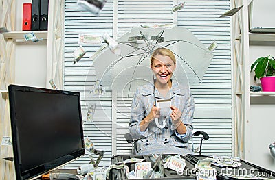 Accountant with pile money hide under umbrella. Accountant enjoy cash rain in office. Cash rain concept. Money falling Stock Photo