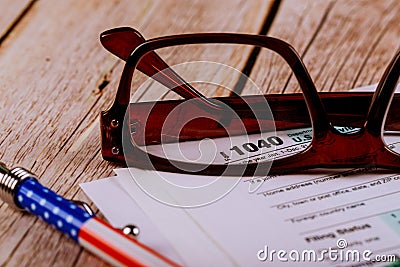 Accountant& x27;s office documents tax form focus on 1040, shallow depth of field with pen, glasses Editorial Stock Photo