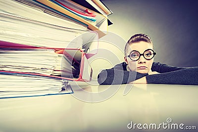 Accountant terrified of pils of binders. Stock Photo