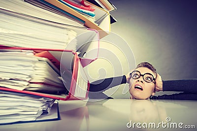 Accountant terrified of pils of binders. Stock Photo