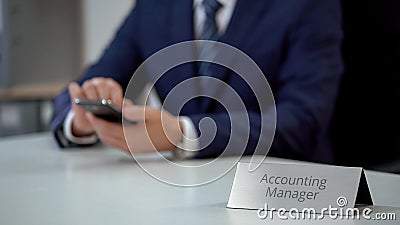 Accounting manager checking email on smartphone, scrolling pages on screen Stock Photo