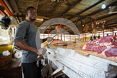 ACCRA, GHANA ï¿½ MARCH 18: Unidentified Ghanaian butcher doing hi Editorial Stock Photo