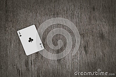 Ace of clubs closeup, playing cards on a wooden background. Risk and Gambling background, abstract and game concept. Stock Photo