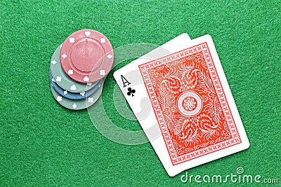 Ace of clubs poker cards with chips on gaming table Stock Photo