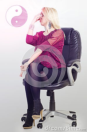 Achieving zen at work, woman looking for creativity at work in office Stock Photo