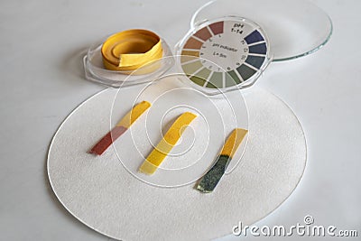 Acid - base detection through litmus paper. The color of the paper identifies an acid or basic solution Stock Photo