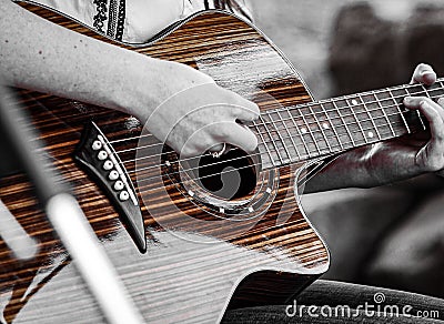 An acoustic guitar being strummed Stock Photo