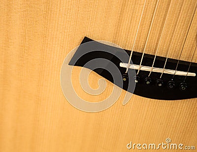 Acoustic guitar close-up. Detailed image of the guitar bridge. Stock Photo