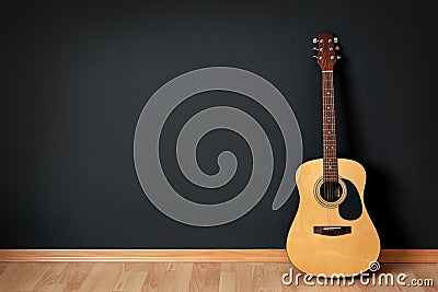 Acoustic guitar in empty room Stock Photo