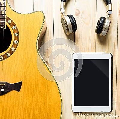Acoustic Guitar with headphone and tablet for music Stock Photo