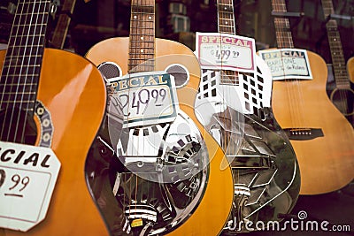 Acoustic guitars on display in shop window Stock Photo