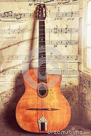 Acoustic Gypsy Jazz Guitar Vintage and Aged with Wear and Music Notes Stock Photo
