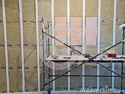 acoustically insulated walls and scaffolding while repair Stock Photo