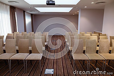 Acoustically satisfactory auditorium with rows of beige chairs Stock Photo